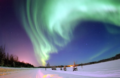 The Aurora Borealis shines above Bear Lake, Alaska